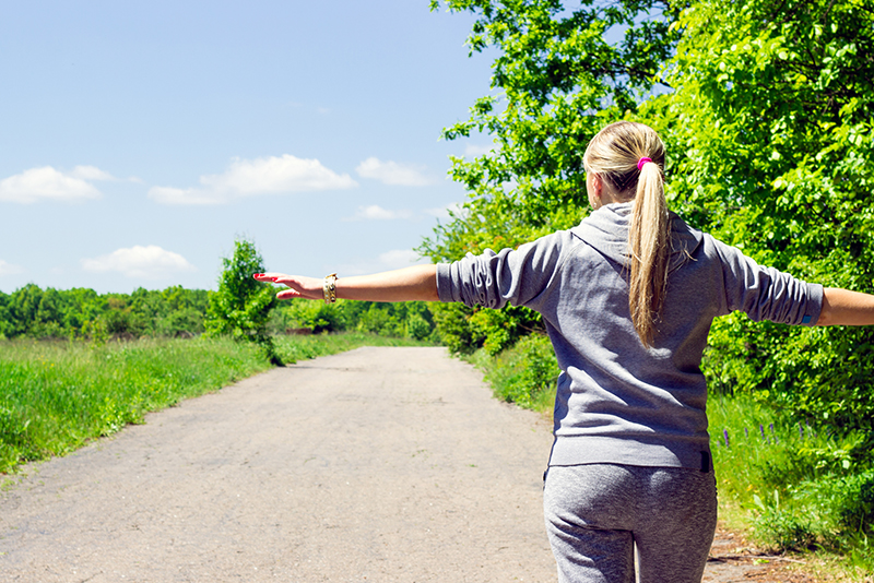 Woman walking alone practicing social distancing